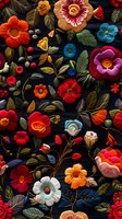Vibrant embroidered floral pattern with colorful flowers and leaves on dark background. Traditional folk art style textile design for fashion and decor.