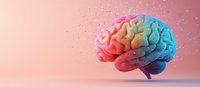 Colorful rainbow human brain model on pink background with glitter particles, representing creativity, mental health, and neuroscience concepts.
