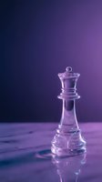 Transparent glass chess queen piece on purple gradient background with dramatic lighting for strategy and leadership concepts.