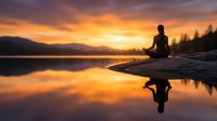 Woman meditating on rock by calm lake at sunrise, silhouetted against golden sky with mountain backdrop and forest. Wellness and mindfulness concept.