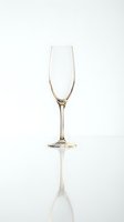 Empty champagne flute glass isolated on white background with reflection for celebration and party design projects.