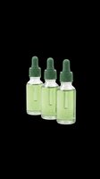 Three green glass dropper bottles filled with light green liquid, isolated on transparent background, ready for cosmetic, skincare, or essential oil product design use on t-shirts, stickers, and print-on-demand items.