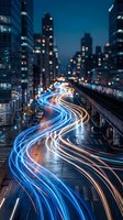Urban night scene with vibrant light trails from traffic creating flowing streams of blue and orange colors through city streets surrounded by illuminated skyscrapers.