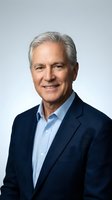 Senior male executive with gray hair, Caucasian ethnicity, wearing navy blazer and light blue shirt. Professional headshot against neutral background for corporate, business, and leadership applications.