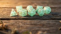 Set of mint green polyhedral gaming dice with golden numbers on rustic wooden surface for tabletop role-playing games and board game adventures.