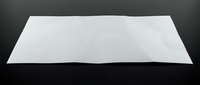 White blank paper sheet with curved edges on dark background for mockup design templates and presentations.