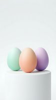 Three colorful Easter eggs in pastel green, peach and purple tones arranged on white platform against neutral background for spring holiday designs.