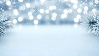 Winter holiday background with snow, bokeh lights and pine branches creating festive atmosphere for seasonal designs and greeting cards.