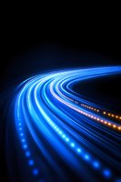 Glowing curved blue and orange light trails on black background create dynamic motion effect, suggesting speed, technology and digital connectivity in modern design.