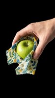 Hand holding green apple wrapped in floral fabric, isolated on transparent background. Ready for design use on t-shirts, clipart, stickers, print-on-demand products, and sublimation projects.