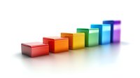 Colorful ascending steps or blocks in rainbow colors from red to purple showing growth, progress, or success concept on white background with reflection.