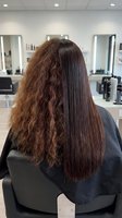 Hair straightening treatment before and after comparison showing frizzy curly hair transformation to smooth straight hair in professional salon chair.