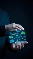 Person holding glowing neon letters and open book icons between hands against dark background, representing digital learning, education technology, and knowledge sharing for online courses.