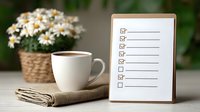 White coffee cup on burlap napkin with checklist and wicker basket of daisies, creating cozy planning atmosphere for productivity and organization.