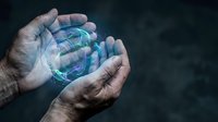 Elderly hands gently holding glowing digital sphere with network connections, representing technology protection, data security, and digital innovation concept.