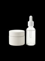 Skincare set with white cream jar and glass dropper serum bottle, isolated on transparent background, ready for beauty product design, stickers, and print on demand.