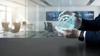 Businessman in dark suit holding glowing digital globe with network connections in modern office environment, representing global business, technology, and international commerce.