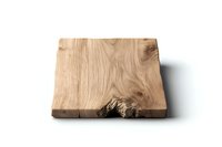 Natural oak wooden cutting board with raw edge and distinctive wood grain pattern on white background, isolated rustic kitchen accessory.