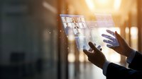 Businessman hands touching holographic digital interface with data analytics charts and graphs in modern office environment for business intelligence.