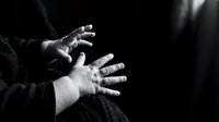 Elderly hands reaching out in dramatic black and white lighting expressing hope, desperation or plea for help in emotional storytelling concept.
