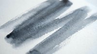 Abstract gray watercolor brush strokes on white paper creating minimalist artistic composition for modern design projects and creative backgrounds.