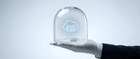 Hand holding transparent glass dome with cloud computing icon inside, representing data protection, network security, and digital infrastructure solutions for business technology.