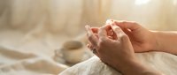 Peaceful meditation hands in mudra position with soft morning light creating serene atmosphere for mindfulness practice and spiritual wellness.