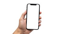 Hand holding modern smartphone with blank white screen isolated on white background for mobile app mockup and digital technology presentation.