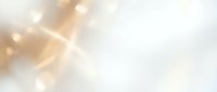 Abstract golden light rays with soft bokeh effects on white background for elegant presentations and luxury branding materials.