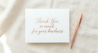 Elegant thank you card with gold calligraphy text and rose gold pen on soft fabric background for gratitude expressions and correspondence.