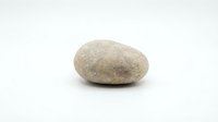 Single smooth river stone isolated on white background for spa wellness meditation zen garden design projects.