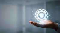 Businessman hand holding glowing shield security icon with digital particles, representing data protection, cybersecurity solutions, and network safety for corporate technology concepts.