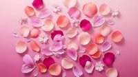 Delicate rose petals and small white flowers scattered on soft pink gradient background creating romantic feminine pattern for wedding invitations.
