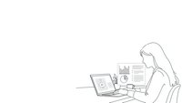 Young professional woman analyzing financial data and charts on laptop computer while reviewing business reports at modern workspace.