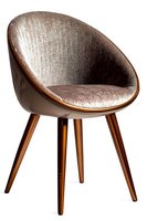 Modern velvet upholstered dining chair with brown plastic shell and wooden legs on white background, contemporary furniture design for home interior.