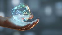 Hand holding glowing digital brain with neural network connections representing artificial intelligence, machine learning and cognitive technology innovation.