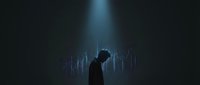 Silhouette of male professional analyzing financial data charts in dark environment with blue light, suitable for business analytics and stock market concepts.