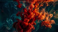 Red ink dissolving in water creating dramatic fiery cloud formations against deep teal background, abstract fluid art for creative backgrounds.