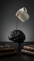 Cream ceramic mug pouring coffee onto black brain model surrounded by books and glasses on dark surface, conceptual art for mental health, creativity, knowledge and learning themes.