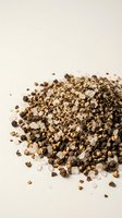 Crushed black peppercorns and coarse salt blend scattered on neutral background for culinary seasoning and cooking applications.