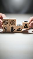 Hands arranging wooden blocks with mental health symbols including brain, heart, hand and medical icons representing wellness and psychological care concepts.