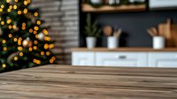 Rustic wooden table surface with blurred Christmas tree lights and modern kitchen interior background, cozy holiday atmosphere for product display.