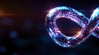 Glowing infinity symbol with sparkling blue and pink particles on dark background creates magical light trail effect. Dynamic motion design element.