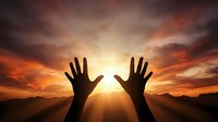 Silhouette of hands reaching toward bright sun during dramatic sunset with orange and pink clouds over mountain landscape creating spiritual moment.