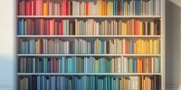 Modern bookshelf with colorful books arranged by spectrum, creating rainbow effect in home library or bookstore interior.