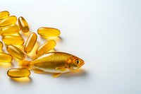 Golden fish swimming among omega-3 fish oil capsules on white background, creative pharmaceutical and dietary supplement composition for health benefits.