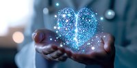 Glowing blue heart made of sparkles and light particles floating above cupped hands in dark setting, representing love, healing and digital transformation.