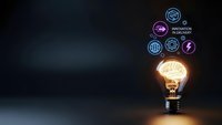Glowing light bulb with brain inside surrounded by floating innovation icons on dark background representing creative thinking and technological advancement.