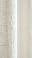 Natural linen fabric texture with visible fibers and weave pattern in neutral beige tones for textile and interior design projects.