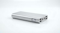 Silver portable power bank with digital display showing battery percentage on white background for electronics and mobile device charging.